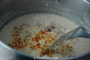 Saffron and cardamom added to thickened sweetened milk